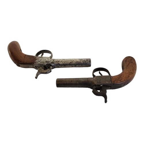 239 - TWO LATE 18TH/EARLY 19TH CENTURY PERCUSSION CAP PISTOLS
Having steel barrels and carved wooden handl... 