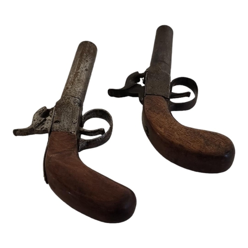 239 - TWO LATE 18TH/EARLY 19TH CENTURY PERCUSSION CAP PISTOLS
Having steel barrels and carved wooden handl... 