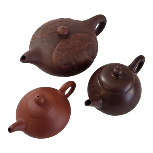 326 - A COLLECTION OF THREE 20TH CENTURY CHINESE TERRACOTTA POTTERY TEAPOTS
To include a teapot with incis... 