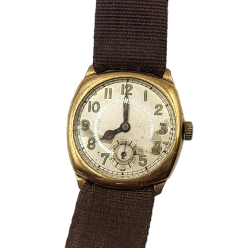 102 - AN EARLY 20TH CENTURY 9ct GOLD GENTS WRISTWATCH
Square form case on brown fabric strap, silver tone ... 