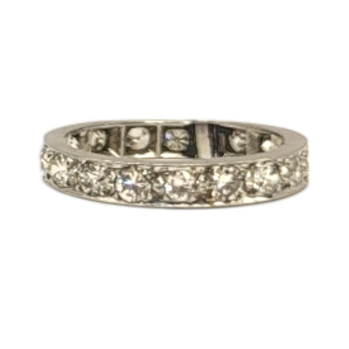 134 - AN EARLY 20TH CENTURY WHITE METAL AND DIAMOND ETERNITY RING
Having a row of round cut stones in plai... 