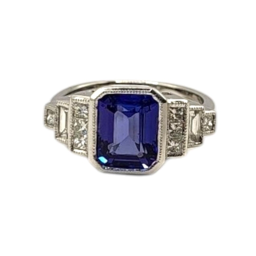 18 - AN 18CT WHITE GOLD, TANZANITE AND DIAMOND RING
The central octagonal cut tanzanite edged with round ... 