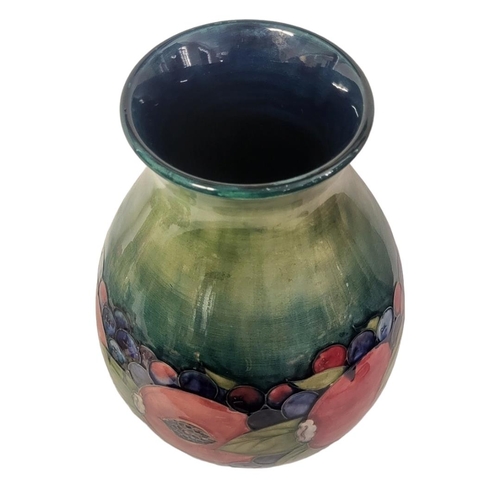 442 - A WILLIAM MOORCROFT POTTERY BALUSTER VASE, CIRCA 1930
In pomegranate, berry and leaf pattern, the bo... 