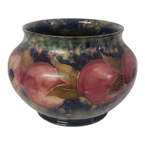 252 - WILLIAM MOORCROFT, AN EARLY 20TH CENTURY OVOID POTTERY JARDINIÈRE, CIRCA 1920
Pomegranate pattern, t... 