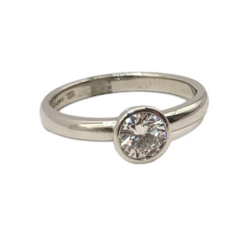 29 - A PLATINUM AND DIAMOND SOLITAIRE RING
The single round cut diamond in a rub over mount.
(approx 0.57... 