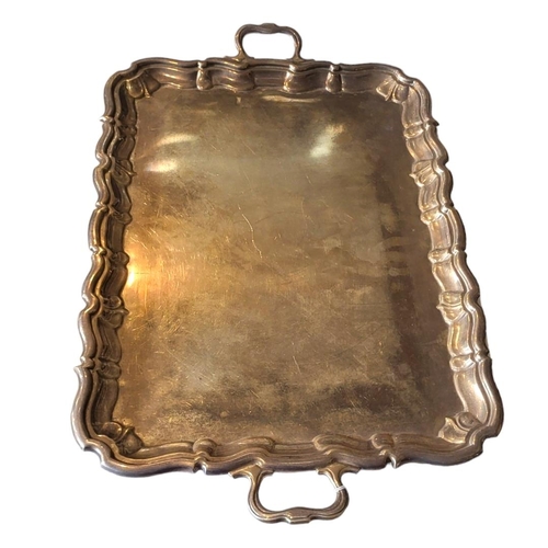 31 - A LARGE EARLY 20TH CENTURY SILVER BUTLER'S TRAY
Having twin handles and scrolled edge, hallmarked Ja... 