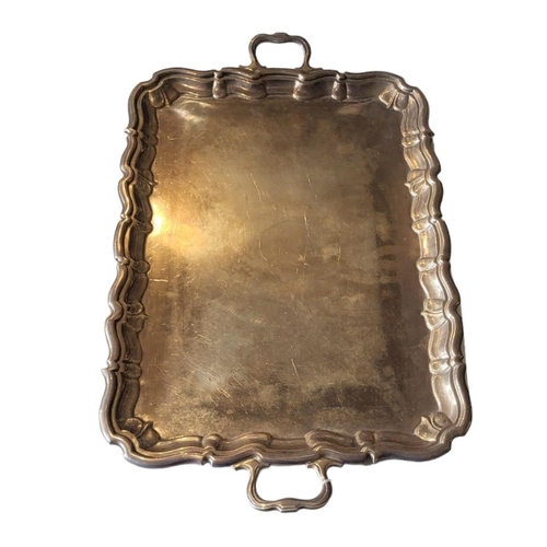 31 - A LARGE EARLY 20TH CENTURY SILVER BUTLER'S TRAY
Having twin handles and scrolled edge, hallmarked Ja... 