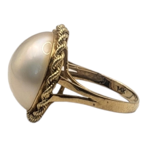 80 - A CONTINENTAL 14CT GOLD AND PEARL RING
The single pearl in a rope twist design on a plain gold mount... 