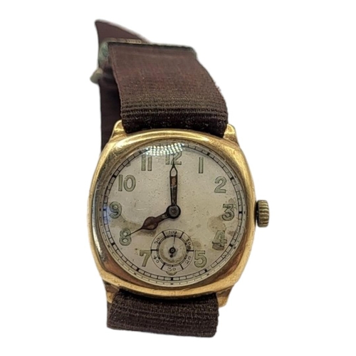 102 - AN EARLY 20TH CENTURY 9ct GOLD GENTS WRISTWATCH
Square form case on brown fabric strap, silver tone ... 