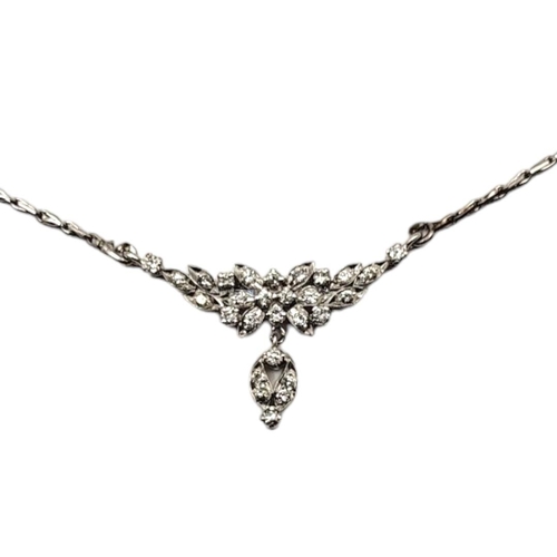 108 - A VINTAGE WHITE METAL AND DIAMOND NECKLACE 
Having an arrangement of round cut stones forming a flor... 