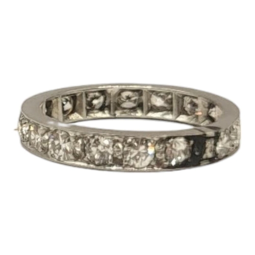 134 - AN EARLY 20TH CENTURY WHITE METAL AND DIAMOND ETERNITY RING
Having a row of round cut stones in plai... 