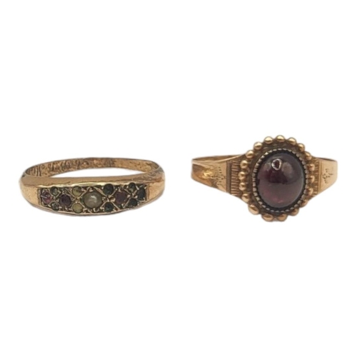 135 - AN EARLY 20TH CENTURY YELLOW METAL AND GARNET RING
The single cabochon cut stone, together with a ye... 