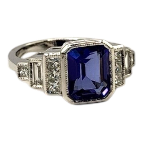 18 - AN 18CT WHITE GOLD, TANZANITE AND DIAMOND RING
The central octagonal cut tanzanite edged with round ... 