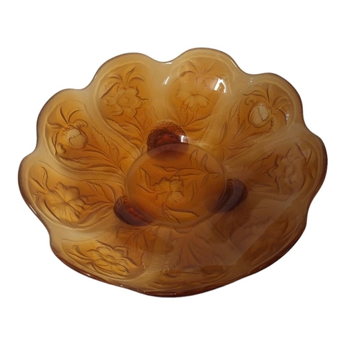 189 - AN EARLY 20TH CENTURY AMBER GLASS BOWL
Having a scalloped edge and embossed floral decoration to rev... 