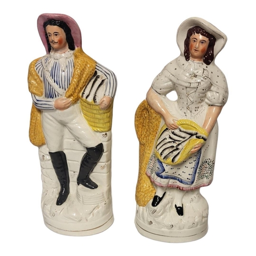 192 - A PAIR OF VICTORIAN STAFFORDSHIRE FLATBACK FIGURES OF A FISHERMAN AND HIS WIFE 
Highlighted with gil... 