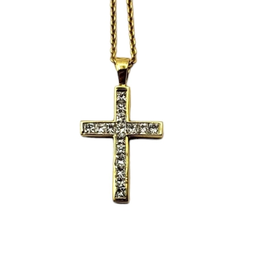 20 - AN 18CT GOLD AND DIAMOND CRUCIFIX PENDANT NECKLACE
Two rows of Princess cut diamonds on a fine link ... 