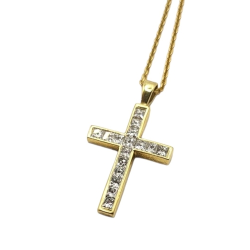 20 - AN 18CT GOLD AND DIAMOND CRUCIFIX PENDANT NECKLACE
Two rows of Princess cut diamonds on a fine link ... 