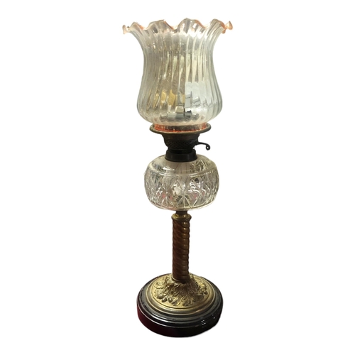 204 - A VICTORIAN BRASS AND CUT GLASS OIL LAMP
Having a fluted glass shade, cut glass oil well and twisted... 