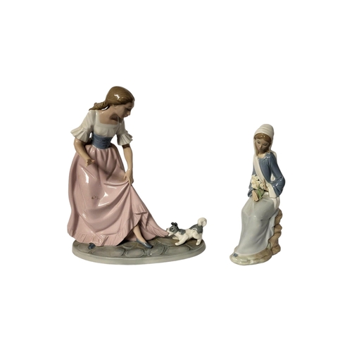 216 - LLADRO, A PORCELAIN FIGURE OF A SEATED MADONNA WITH HOLY LILIES 
Painted in monochrome glazes, along... 