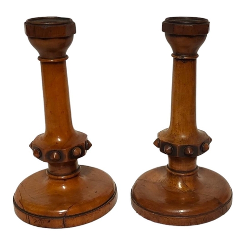 219 - A PAIR OF 19TH CENTURY BOXWOOD CANDLESTICKS
Having octagonal sconce and carved decoration to central... 