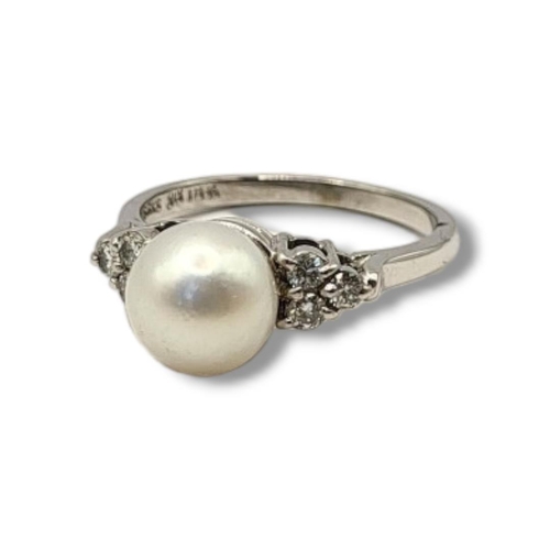 22 - AN 18CT WHITE GOLD, DIAMOND AND CULTURED PEARL RING
The single cultured pearl flanked by round cut d... 