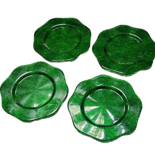 225 - A SET OF FOUR LARGE MID CENTURY GREEN GLASS CHARGER PLATES
Having a scalloped edge and textured desi... 