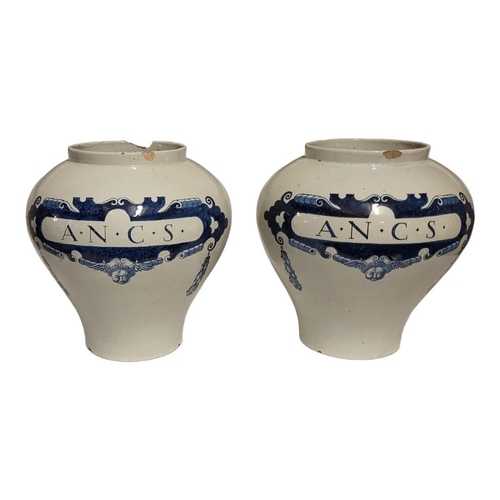 228 - A LARGE PAIR OF EARLY 20TH CENTURY DUTCH DELFT OVOID POTTERY JARS
With underglaze blue cartouche and... 