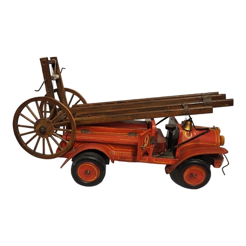 231 - A 20TH CENTURY CARVED WOODEN FIRE ENGINE
Having carved telescopic ladders and red hand painted liver... 