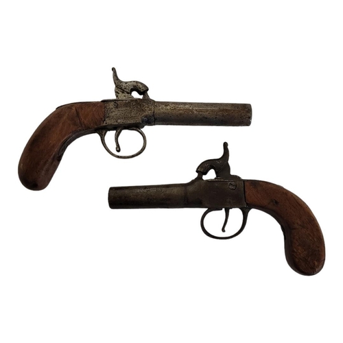 239 - TWO LATE 18TH/EARLY 19TH CENTURY PERCUSSION CAP PISTOLS
Having steel barrels and carved wooden handl... 