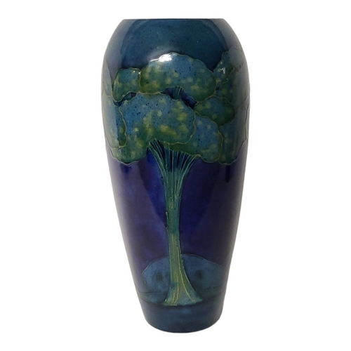 247 - WILLIAM MOORCROFT, A TALL EARLY 20TH CENTURY POTTERY VASE
Moonlight blue pattern, Circa 1925, tubeli... 