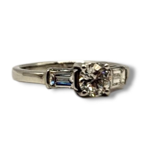 25 - AN 18CT WHITE GOLD AND DIAMOND THREE STONE RING
The central round d cut diamond with baguette cut di... 