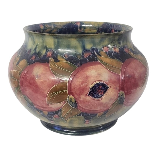 252 - WILLIAM MOORCROFT, AN EARLY 20TH CENTURY OVOID POTTERY JARDINIÈRE, CIRCA 1920
Pomegranate pattern, t... 