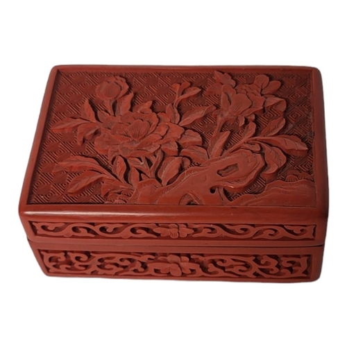 269 - A CHINESE 20TH CENTURY RED CINNABAR LACQUER TRINKET BOX AND COVER
The cover decorated with blossomin... 