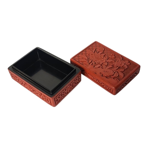 269 - A CHINESE 20TH CENTURY RED CINNABAR LACQUER TRINKET BOX AND COVER
The cover decorated with blossomin... 