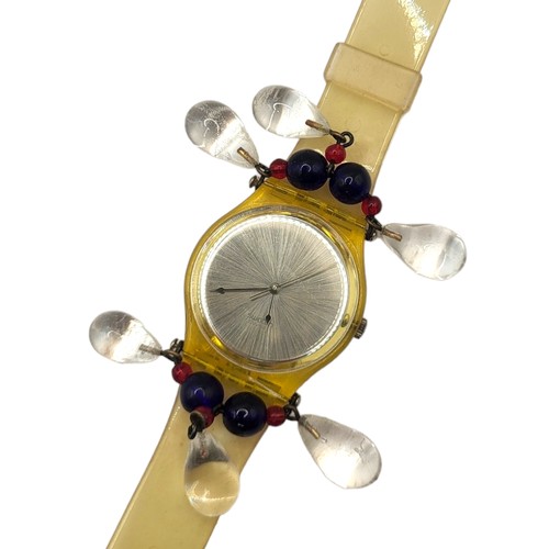 6B - SWATCH, A VINTAGE CHANDELIER WRISTWATCH
Set in glass frame with glass beads, in a fitted wooden box.... 