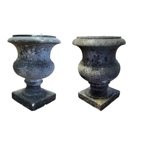 417 - A PAIR OF 19TH CENTURY MARBLE URNS
On a socle and plinth bases.
(25cm)

Condition: weathered, few ni... 