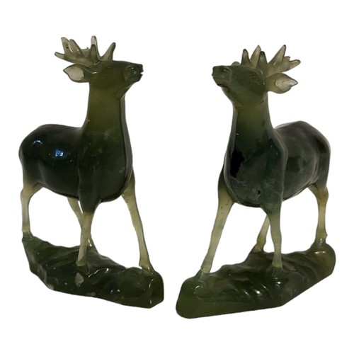 439 - A PAIR OF ORIENTAL SPINACH GREEN JADE CARVINGS OF STAGS
Carved and modelled in relief, with naturali... 