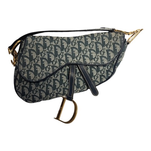 468 - CHRITIAN DIOR, A VINTAGE LEATHER AND CANVAS SADDLE BAG
Blue leather strap with gilt attachments and ... 