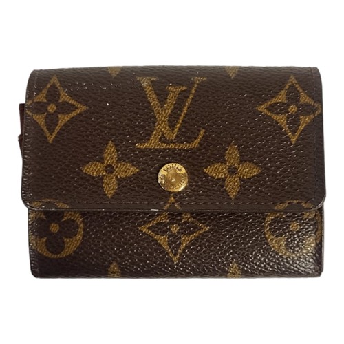 469 - LOUIS VUITTON, A BROWN LEATHER  ELISE MONOGRAM SMALL WALLET
With gilt brass button and two internal ... 