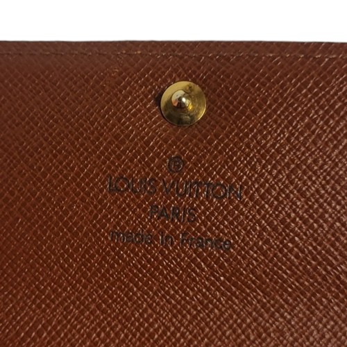 469 - LOUIS VUITTON, A BROWN LEATHER  ELISE MONOGRAM SMALL WALLET
With gilt brass button and two internal ... 