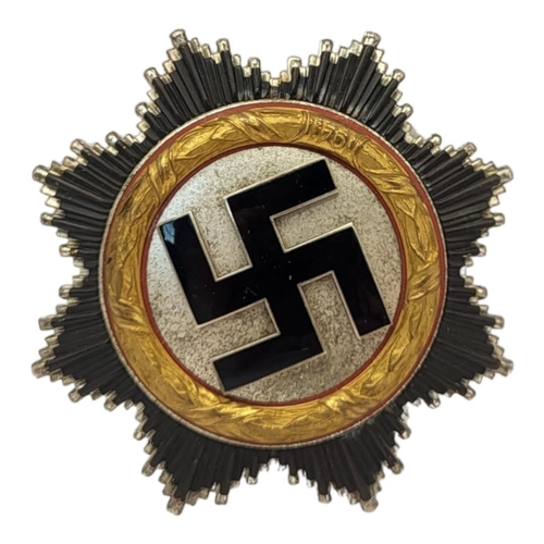 552 - A GERMAN WWII WAR ORDER OF THE GERMAN CROSS MEDAL
Gold bezel dated1941, black enamel swastika.
(appr... 