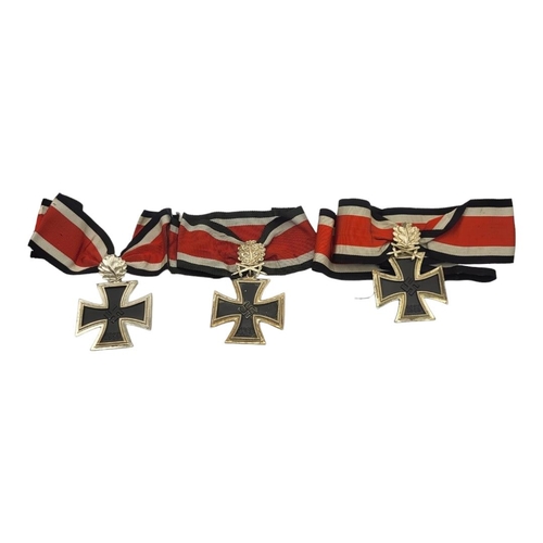 560 - A COLLECTION OF THREE WWII GERMAN IRON CROSS WITH OAK LEAF MEDALS, DATED 1813 - 1939 (GOOD COPIES)
W... 