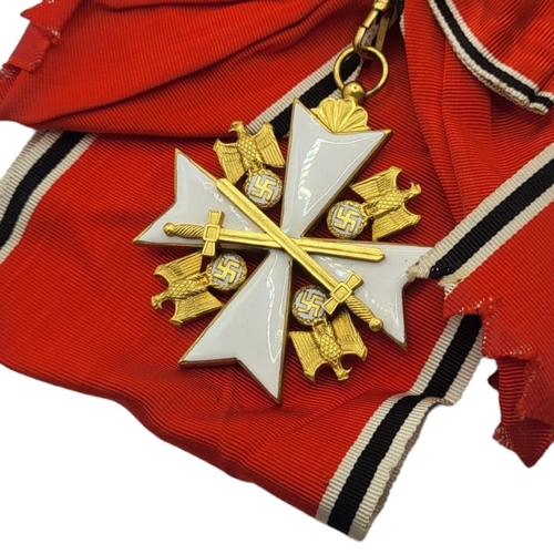 566 - A WWII GERMAN EAGLE STAR BREAST BADGE AND  MEDAL
White metal with enamel on red, black and white rib... 