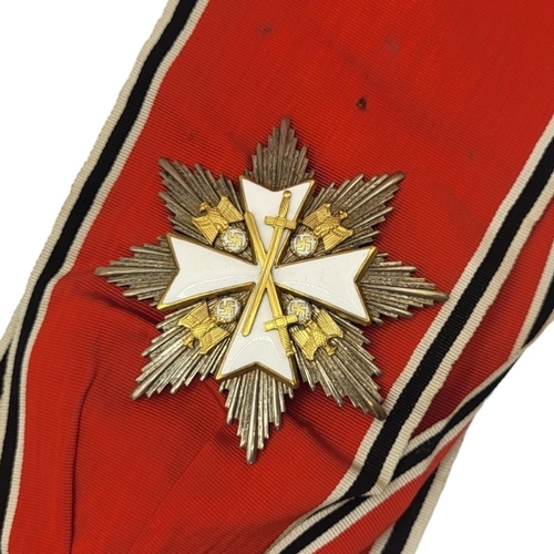 566 - A WWII GERMAN EAGLE STAR BREAST BADGE AND  MEDAL
White metal with enamel on red, black and white rib... 