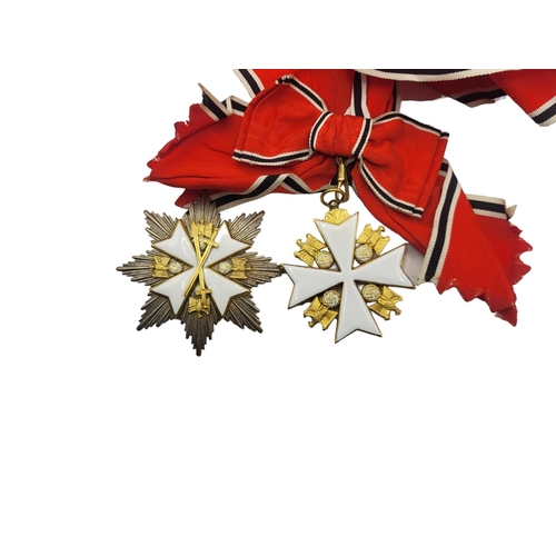 566 - A WWII GERMAN EAGLE STAR BREAST BADGE AND  MEDAL
White metal with enamel on red, black and white rib... 