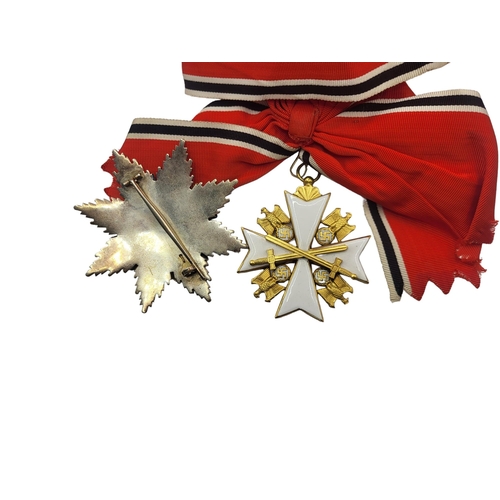 566 - A WWII GERMAN EAGLE STAR BREAST BADGE AND  MEDAL
White metal with enamel on red, black and white rib... 