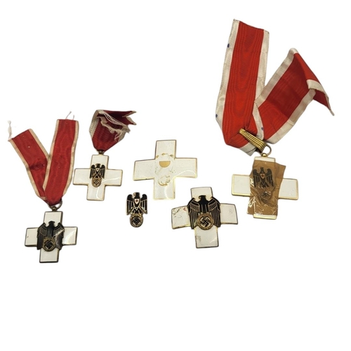 569 - A WWII GERMAN RED CROSS BREAST BADGE,MEDAL AND BADGE
Black enamel eagle and swastika on white enamel... 