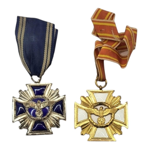 572 - TWO WWII GERMAN NSDAP LONG SERVICE MEDALS
White metal with blue enamel and gilt metal with white ena... 