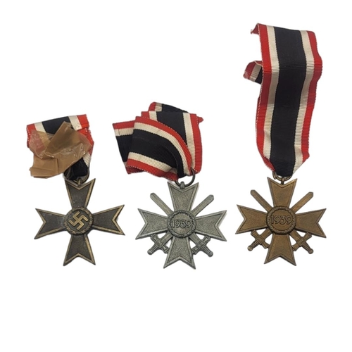 580 - A COLLECTION OF THREE WWII GERMAN WAR MERIT CROSS MEDALS
Two with swords, marked 1936.