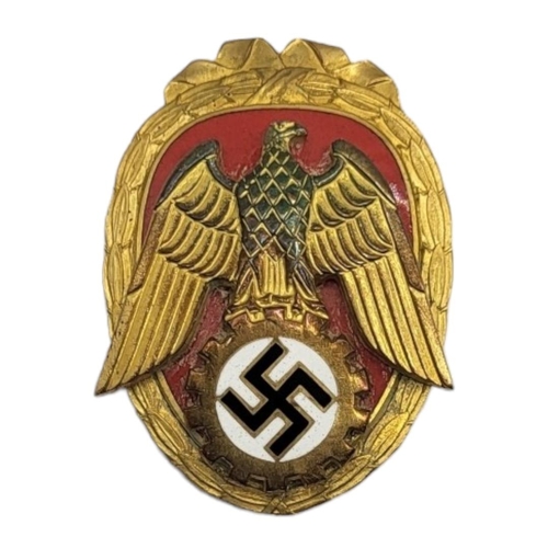 586 - A WWII GERMAN PIONEER OF LABOUR BADGE
Oval form with enamel swastika and whale on red enamel ground.... 